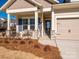 Inviting front porch with a stone base and a welcoming bench at 1118 Lowland Way, Waxhaw, NC 28173