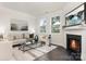 Bright living room features a fireplace, modern decor, and large windows offering ample natural light at 115 Sari St, Troutman, NC 28166