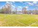 Community volleyball net in a field, surrounded by mature trees and other houses at 2060 E Foxwood Ct, Indian Land, SC 29707