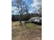 View of backyard with fire pit and patio area in the distance at 949 Grace Ave, Lancaster, SC 29720
