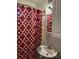 Bathroom featuring a patterned shower curtain, bright lighting, and a classic sink at 949 Grace Ave, Lancaster, SC 29720