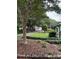 Landscaped front yard of a single-story home with mature trees and a well-kept lawn at 949 Grace Ave, Lancaster, SC 29720