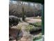 View of the front yard featuring well-kept bushes and gardens from the covered front porch at 949 Grace Ave, Lancaster, SC 29720