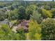 Aerial view of a home with a brown roof surrounded by lush trees and landscaping at 405 7Th St, Spencer, NC 28159