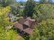 An aerial view of a home and yard with a brown roof and mature trees at 405 7Th St, Spencer, NC 28159