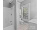 Bathroom with white fixtures, tile floor, and bathtub at 405 7Th St, Spencer, NC 28159