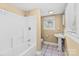 Clean bathroom featuring a tub/shower, a pedestal sink, and neutral tile flooring at 405 7Th St, Spencer, NC 28159