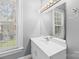 Bathroom with white vanity, mirror, and natural light at 405 7Th St, Spencer, NC 28159