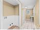 Well-lit bathroom with a tub/shower combo, a pedestal sink, and a convenient laundry area at 405 7Th St, Spencer, NC 28159