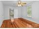 Bright bedroom with hardwood floors, a ceiling fan, and a large window at 405 7Th St, Spencer, NC 28159