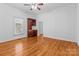 Spacious bedroom with beautiful hardwood floors, a ceiling fan, and a built-in bar area at 405 7Th St, Spencer, NC 28159