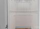 Walk-in closet with white shelves and beadboard paneling at 405 7Th St, Spencer, NC 28159