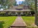 Charming home featuring a brick walkway, manicured lawn, and a welcoming front porch at 405 7Th St, Spencer, NC 28159