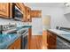 Charming kitchen featuring wooden cabinets, tile backsplash, and stainless steel appliances at 405 7Th St, Spencer, NC 28159
