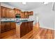 Kitchen with wooden cabinets, granite countertops, functional island and modern appliances at 405 7Th St, Spencer, NC 28159