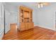 Bright living room with hardwood floors and custom built-in wooden cabinet with storage at 405 7Th St, Spencer, NC 28159