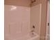 Clean bathtub with shower fixture in a simple bathroom at 602 Glenn St, Gastonia, NC 28052