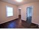 Bedroom with dark hardwood floors and access to two rooms at 602 Glenn St, Gastonia, NC 28052