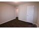 Simple bedroom with dark hardwood floors and access to another room at 602 Glenn St, Gastonia, NC 28052