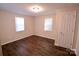 Bedroom with dark brown wood floors and two windows at 602 Glenn St, Gastonia, NC 28052