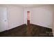 Simple bedroom with dark hardwood floors and access to another room at 602 Glenn St, Gastonia, NC 28052