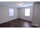 Bedroom with dark hardwood floors and two windows at 602 Glenn St, Gastonia, NC 28052