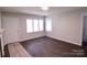 Living room with wood floors, white door and windows at 602 Glenn St, Gastonia, NC 28052