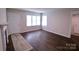 Living room with wood floors, white door and windows at 602 Glenn St, Gastonia, NC 28052