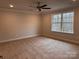 Cozy bedroom with neutral walls, carpet, a ceiling fan and large window with natural light at 4069 Port Richmond Ave # 16, Gastonia, NC 28056