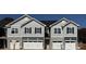 New construction townhome exterior with gray siding, stone accents, and white garage doors at 4069 Port Richmond Ave # 16, Gastonia, NC 28056