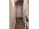 Hallway that shows access to half bath and door to unfinished storage space at 4081 Port Richmond Ave # 19, Gastonia, NC 28056