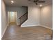 Bright living room featuring wood-look floors and staircase with decorative iron spindles at 4081 Port Richmond Ave # 19, Gastonia, NC 28056