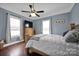 Bright bedroom with wood floors, ceiling fan, and large windows at 410 Gaddy St, Kannapolis, NC 28081