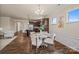 Open-concept dining area connecting to a kitchen and sitting room, featuring modern lighting and stylish decor at 984 Kirby Dr, Fort Mill, SC 29715