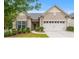 Charming single-story home featuring manicured landscaping, a two-car garage and a welcoming entrance at 984 Kirby Dr, Fort Mill, SC 29715
