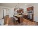 Spacious kitchen featuring dark wood cabinets, stainless steel appliances, and a center island with barstool seating at 984 Kirby Dr, Fort Mill, SC 29715
