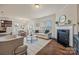 Bright living room with a fireplace, hardwood floors, and a view of the kitchen and dining area at 984 Kirby Dr, Fort Mill, SC 29715