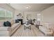 Bright living room with a fireplace, hardwood floors, and neutral decor creating an inviting atmosphere at 984 Kirby Dr, Fort Mill, SC 29715