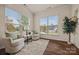 Cozy sitting room filled with natural light from large windows, complemented by comfortable armchairs and hardwood floors at 984 Kirby Dr, Fort Mill, SC 29715