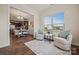 Inviting sitting room with hardwood floors and outside views, adjacent to a dining area with modern furnishings at 984 Kirby Dr, Fort Mill, SC 29715