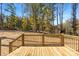 Wooden deck with railings and staircase overlooking the wooded yard in the background at 1128 Bethesda Rd, Statesville, NC 28677