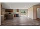 Open concept kitchen with brown cabinets, island and sliding glass door to back deck at 1128 Bethesda Rd, Statesville, NC 28677