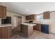 Kitchen featuring dark cabinets and island with a view of the walk-in pantry at 1128 Bethesda Rd, Statesville, NC 28677