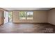 Bright, open living area with wood-look floors, large windows, and a view of the outdoors at 1128 Bethesda Rd, Statesville, NC 28677