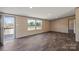 Well-lit living room with wood-look floors, expansive view, and an open layout perfect for entertaining at 1128 Bethesda Rd, Statesville, NC 28677