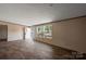 Bright, airy living room with wood-look floors, a large window, and a welcoming entrance at 1128 Bethesda Rd, Statesville, NC 28677