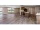 Open-concept living space leading to a kitchen, featuring wood-look floors and ample natural light at 1128 Bethesda Rd, Statesville, NC 28677