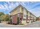 Rear view of townhome showing multiple units and private garages at 1412 W 4Th St, Charlotte, NC 28208