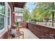 Cozy brick front porch with wicker chairs and a small table, perfect for relaxing at 1412 W 4Th St, Charlotte, NC 28208