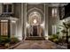 Grand home entrance featuring an arched entryway, elegant lighting, and stone pathway at 1873 Farrow Dr, Rock Hill, SC 29732